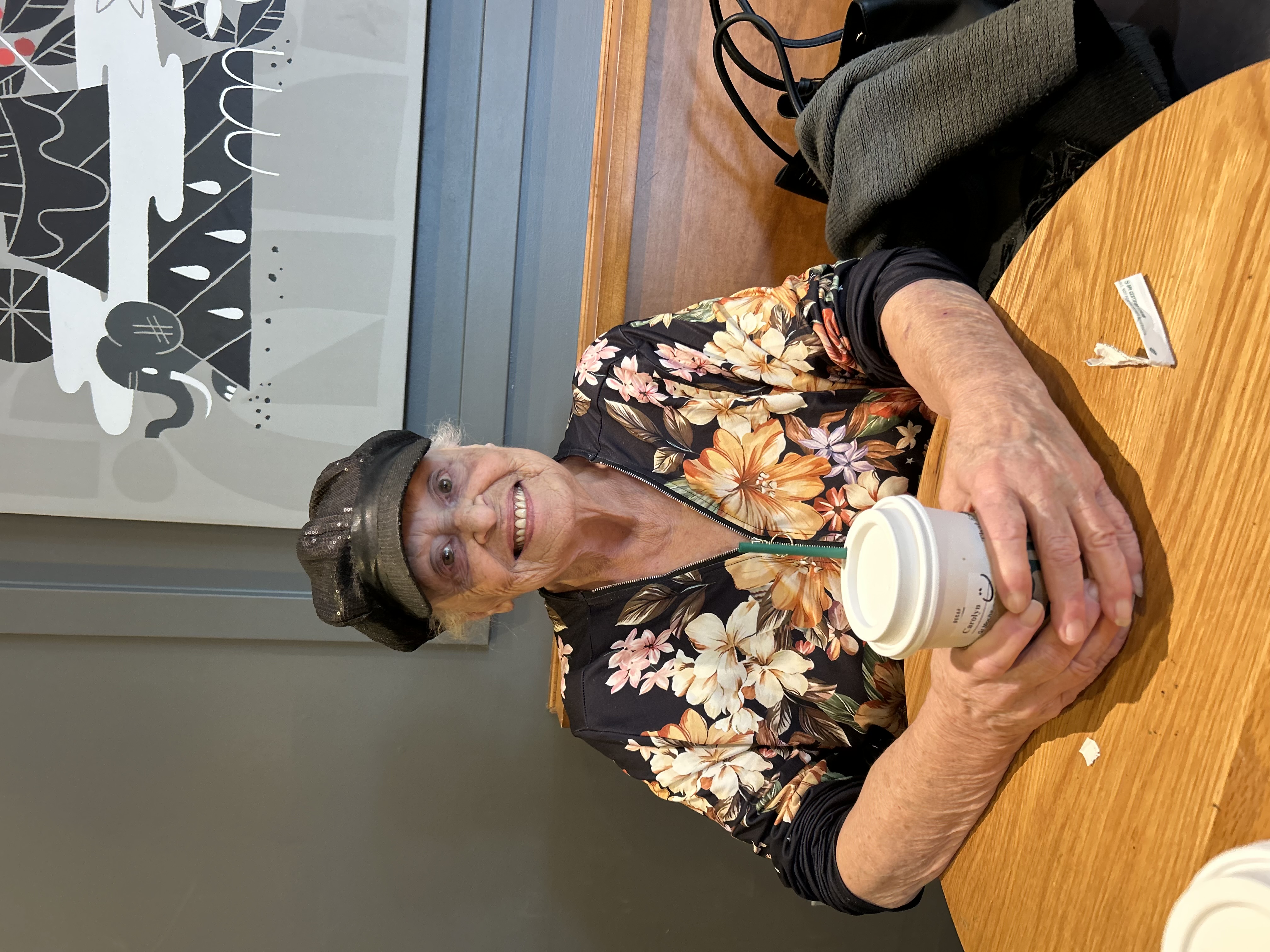Carolyn drinking a coffee at a café.